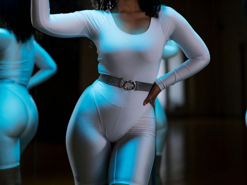 Athletic person doing dynamic movements in a modern gym studio