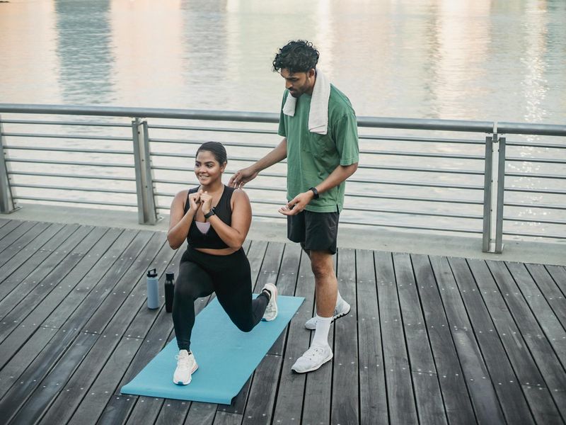 Person doing lunges in a bright fitness studio